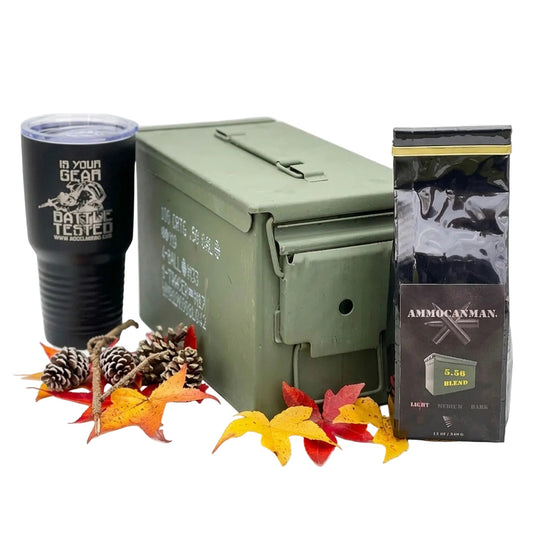 Green ammunition canister with black tumbler and coffee package on a white background